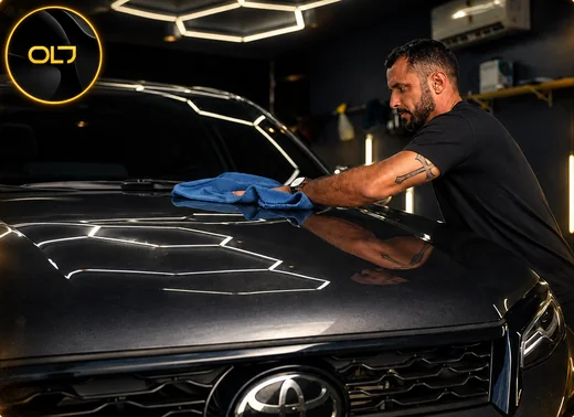 Lava jato e estética automotiva da OLJ em Caruaru: SUV escuro com pintura brilhando no box